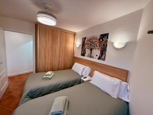 Postel nebo postele na pokoji v ubytování APARTAMENTO EN EL CENTRO CERCA DE La PLAYA