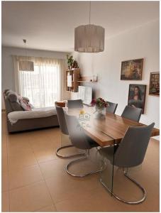 Un comedor con mesa y sillas de madera. en Casa MarTeu, en Pêra