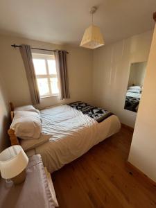 a bedroom with a bed and a window at Beach Haven Portstewart in Portstewart