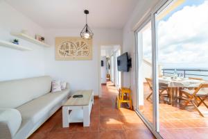 una sala de estar con un sofá y una mesa en Fabuloso Atico Con Vistas Al Mar, en Carboneras