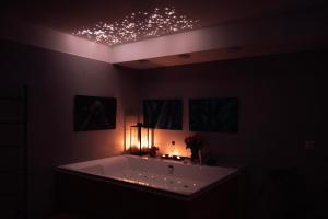 a bathroom with a tub with lights on the ceiling at Luxusný apartmán Bojnice s privátnym wellness in Bojnice