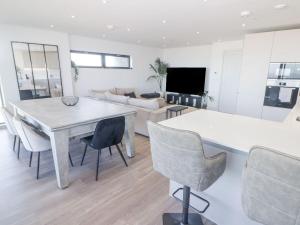 a kitchen and living room with a table and chairs at Seafront apartment with spectacular views in Porthcawl