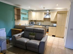 a living room with a couch and a kitchen at Tees Valley Apartments in Middlesbrough