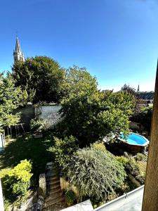 a view of a yard with a swimming pool and trees at Aquarelle in Sainte-Maure-de-Touraine