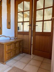 a bathroom with wooden doors and a tiled floor at Zeegalm Bungalows in Middelkerke