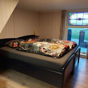 a bed with a blanket on it in a bedroom at De Mast bij Fort Vechten on the countryside & close to Utrecht in Bunnik