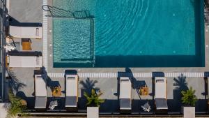 an overhead view of a swimming pool with chairs next to it at Villa Llaha Gabrijela - Luxurious Private Escape with Pool in Nature - By Villa Mana Gers in Gaïtánion
