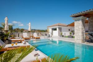 a swimming pool in a villa with a patio at Villa Llaha Gabrijela - Luxurious Private Escape with Pool in Nature - By Villa Mana Gers in Gaïtánion