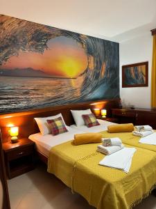 two beds in a room with a painting on the wall at Apartments Krapina Lux in Budva