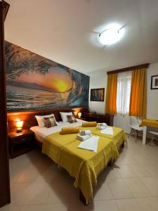 a bedroom with two beds and a painting on the wall at Apartments Krapina Lux in Budva +71 photos