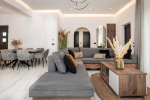 a living room with a couch and a table at Villa Llaha Gabrijela - Luxurious Private Escape with Pool in Nature - By Villa Mana Gers in Gaïtánion +36 photos