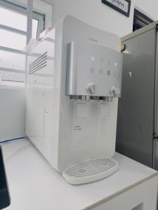 a white coffee maker sitting on top of a counter at 3Bedroom Landed Cozy Home Ipoh Netflix in Ipoh