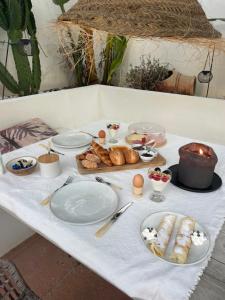 a table with plates of food and bread on it at B&B Villa Victoria in Mijas