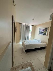 a bedroom with a bed and a window at Várzea HOTEL in Sobral +12 photos