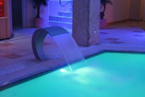 a swimming pool with a tunnel in the water at The Cliff Hotel & Spa in Cardigan +16 photos