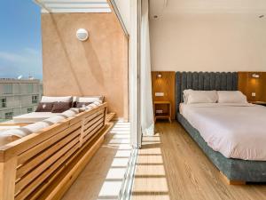 a bedroom with two beds on a balcony at Luxurious Loft, Pool View in Tamraght Ouzdar