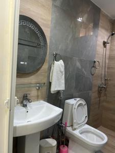 a bathroom with a sink and a toilet and a mirror at Les résidences Astou et Ndiaga in Dakar +29 photos