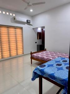 a bedroom with a bed in a room at Cheers Home Stay in Pala