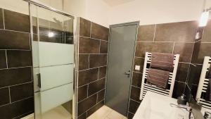 a bathroom with a shower with a glass door at Charmant T2 au coeur d'Angers in Angers