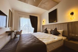 a hotel room with a large bed with a window at Dorana Art Hotel in Kyrenia
