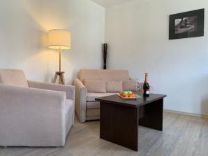 a living room with a couch and a table at Banderitsa Apartments by BookVillaBG in Bansko
