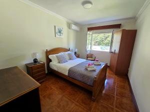 a small bedroom with a bed and a window at Ocean Breeze in Ponta Delgada
