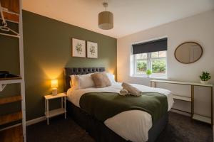 a bedroom with a large bed and a window at Babbage House By Horizon Stays in Stockton-on-Tees