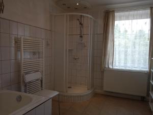 a bathroom with a shower and a tub and a sink at Wohnung In Hänichen Mit Garten in Bannewitz