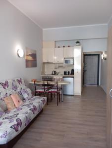 a living room with a couch and a kitchen at Festa Studio in Pomorie