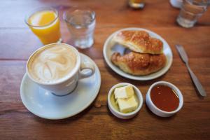 a table with a cup of coffee and a plate of food at Hotel Petit Cordoba in Córdoba