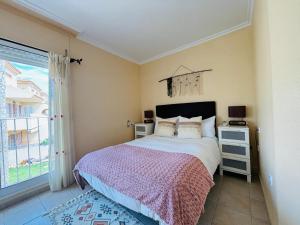 a bedroom with a large bed and a window at Casa Brisa Mediterranea by Rental Hero in Los Alcázares