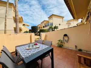 a table and chairs on the patio of a house at Casa Brisa Mediterranea by Rental Hero in Los Alcázares