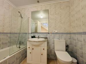 a bathroom with a sink and a toilet and a mirror at Casa Brisa Mediterranea by Rental Hero in Los Alcázares