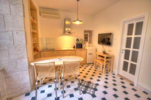 a kitchen with a table and chairs in a room at Petrizio Palace in Zadar +30 photos