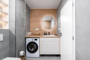 a bathroom with a washing machine and a sink at City Center Apartment MASARYKOVA in Prešov