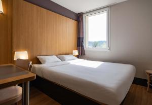 Ένα ή περισσότερα κρεβάτια σε δωμάτιο στο B&B HOTEL Aubenas