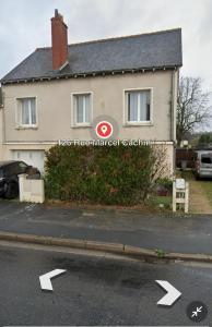 a house with a sign on the side of a street at Maison cosy proche gare SNCF 2 chambres in Saint-Pierre-des-Corps