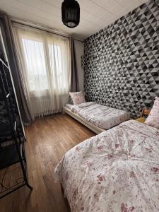 a bedroom with two beds and a window at Maison cosy proche gare SNCF 2 chambres in Saint-Pierre-des-Corps +13 photos