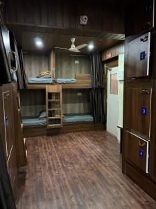 a room with two bunk beds and a kitchen at City Stay Deluxe AC Dormitory in Madgaon