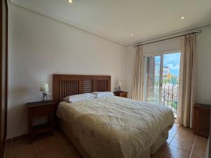 a bedroom with a bed and a large window at Apartamento Al Andalus Hill - Vera Playa in Vera +43 photos