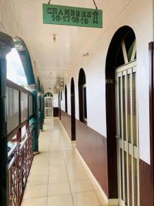 an empty hallway of a building with a sign on it at Chambre spacieuse à SIDI in Bafoussam +8 photos