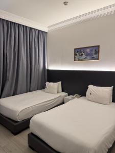 Postel nebo postele na pokoji v ubytování Ny Suites + 37 fotografií