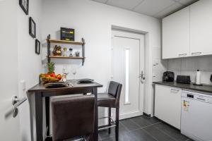 a kitchen with a table with a bowl of fruit on it at Schängel Chic 19 in Koblenz