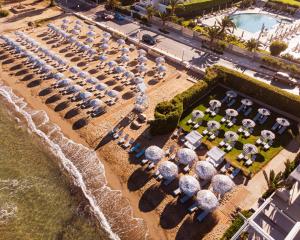 an overhead view of a beach with chairs and umbrellas at Divani Apollon Palace & Thalasso in Athens +37 photos