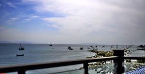 a group of boats in the water near a fence at Chill Days @ Koh Larn in Ko Larn