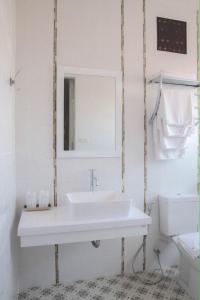 a white bathroom with a sink and a mirror at Chill Days @ Koh Larn in Ko Larn