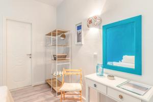 a room with a desk and a blue picture on the wall at Pleasure Corfù Fish in Agios Georgios
