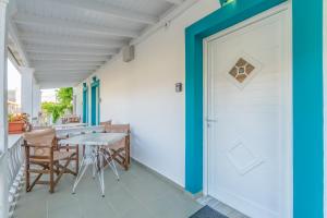 a door to a patio with a table and chairs at Pleasure Corfù Fish in Agios Georgios +42 photos