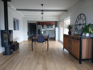 a living room with a dining room table and a kitchen at Maison avec terrasse Davézieux in Davézieux