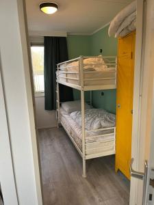 a room with two bunk beds and a window at Veluwse Vlucht in Putten